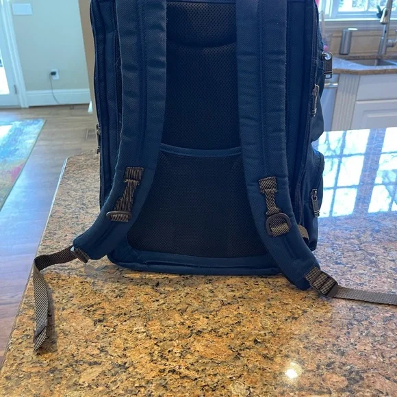 Tumi blue and black backpack. All zips & interior excellent. Two small spots.